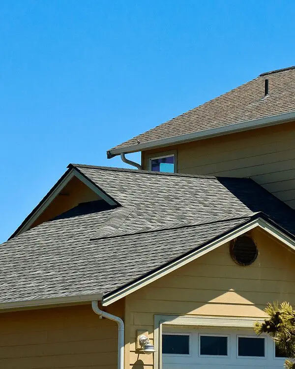 House with gray roof under clear sky.