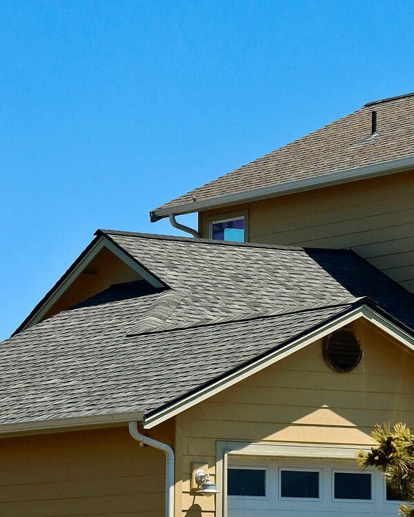 House with gray roof under clear sky.