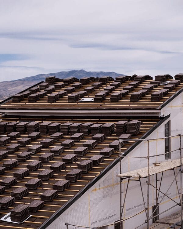Roof under construction with stacked tiles.